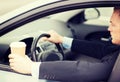 Man drinking coffee while driving the car Royalty Free Stock Photo