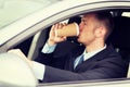 Man drinking coffee while driving the car Royalty Free Stock Photo
