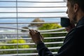 Man drinking coffee and looking through the window at morning Royalty Free Stock Photo