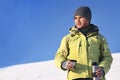 Man drinking hot coffee in thermos mug and looking into the mountains in snow, winter hike Royalty Free Stock Photo