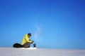 Man drinking hot coffee in thermos mug and looking into the mountains in snow, winter hike Royalty Free Stock Photo