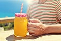 Man drinking an orange beverage in a mason jar