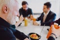 Man drinking organic juice in the office cafeteria and smiling