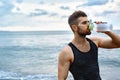 Man Drinking Refreshing Water After Workout At Beach. Drink Royalty Free Stock Photo