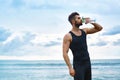 Man Drinking Refreshing Water After Workout At Beach. Drink Royalty Free Stock Photo