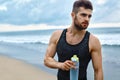 Man Drinking Refreshing Water After Workout At Beach. Drink Royalty Free Stock Photo