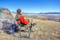 Man drinking tea or coffee in mountains.