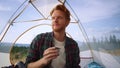 Man drinking tea from cup in morning. Male hiker enjoying coffee during hike Royalty Free Stock Photo