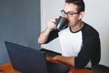 Man drinking tea while working from home