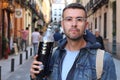 Man drinking an unhealthy amount of soda outdoors