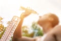 Man drinking water in extreme heat, Thermometer in summer day shows or indicate high temperature