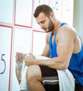 Man drinking water in locker room