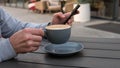 A man drinks cappuccino with a smartphone in his hand in a cozy restaurant,in a cafe drinking coffee and talking on the phone Royalty Free Stock Photo