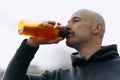 a man drinks water after running. the athlete quenches his thirst