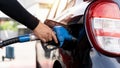 Man driver hand refilling and pumping gasoline oil the car with fuel at he refuel station. Car refueling on petrol station. Fuel Royalty Free Stock Photo