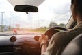 Man driver hands holding the car steering panel