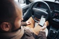 Man driver holding mobile phone with gps application in his car, modern navigation technology for travel and driving concept Royalty Free Stock Photo