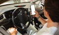 Man driver holding mobile phone with white blank screen Royalty Free Stock Photo