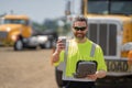 Man driver with lunch box. Truck driver having take away lunch drink coffee to go. Trucker trucking owner