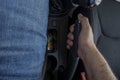 Man driver's hand pulling the handbrake in the car. Royalty Free Stock Photo