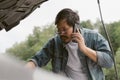 Man driver is using a mobile phone to call for help after car breakdown. Royalty Free Stock Photo