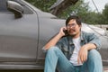 Man driver is using a mobile phone to call for help after car breakdown. Royalty Free Stock Photo