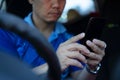 Man driver using smart phone in car Royalty Free Stock Photo