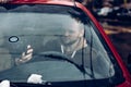 Man driver using smart phone in car, modern internet technology communication concept Royalty Free Stock Photo