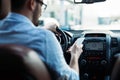 Man driver using smart phone on road in car Royalty Free Stock Photo