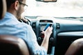 Man driver using smart phone on road in car Royalty Free Stock Photo