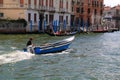 Man drives the blue motorboat with wooden chest. Small DOF Royalty Free Stock Photo