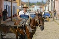 Man drives horse driven carriage at the street of Trinidad town, Cuba. Royalty Free Stock Photo