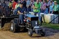 A Man Drives at a Lawn Tractor Pull