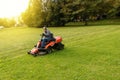 Man drives a lawnmower