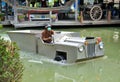 A man driving an amphibious truck at a floating market in Thailand.