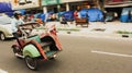 A man driving a bicycle rickshaw fast