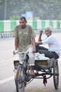 Man driving a bicycle rickshaw in New Delhi, India