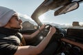 Man driving cabriolet car on the desert road