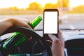 A man driving a car with a bottle of beer and phone Royalty Free Stock Photo