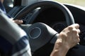 Man driving car, close-up. Driver hands holding steering wheel Royalty Free Stock Photo