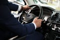 Man driving car, closeup view of hands on steering wheel Royalty Free Stock Photo