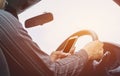 Man driving car. Hands of male is driver on steering wheel car. Royalty Free Stock Photo