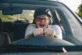 Man driving car in helmet with horror on her face Royalty Free Stock Photo