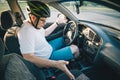 Man driving car in helmet with horror on her face Royalty Free Stock Photo