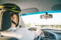 Man driving car in helmet with horror on her face Royalty Free Stock Photo