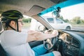 Man driving car in helmet with horror on her face Royalty Free Stock Photo