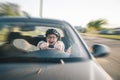 Man driving car in helmet with horror on her face Royalty Free Stock Photo