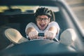 Man driving car in helmet with horror on her face Royalty Free Stock Photo