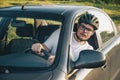 Man driving car in helmet with horror on her face Royalty Free Stock Photo