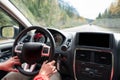 Man driving a car on the highway in autumn forest Royalty Free Stock Photo